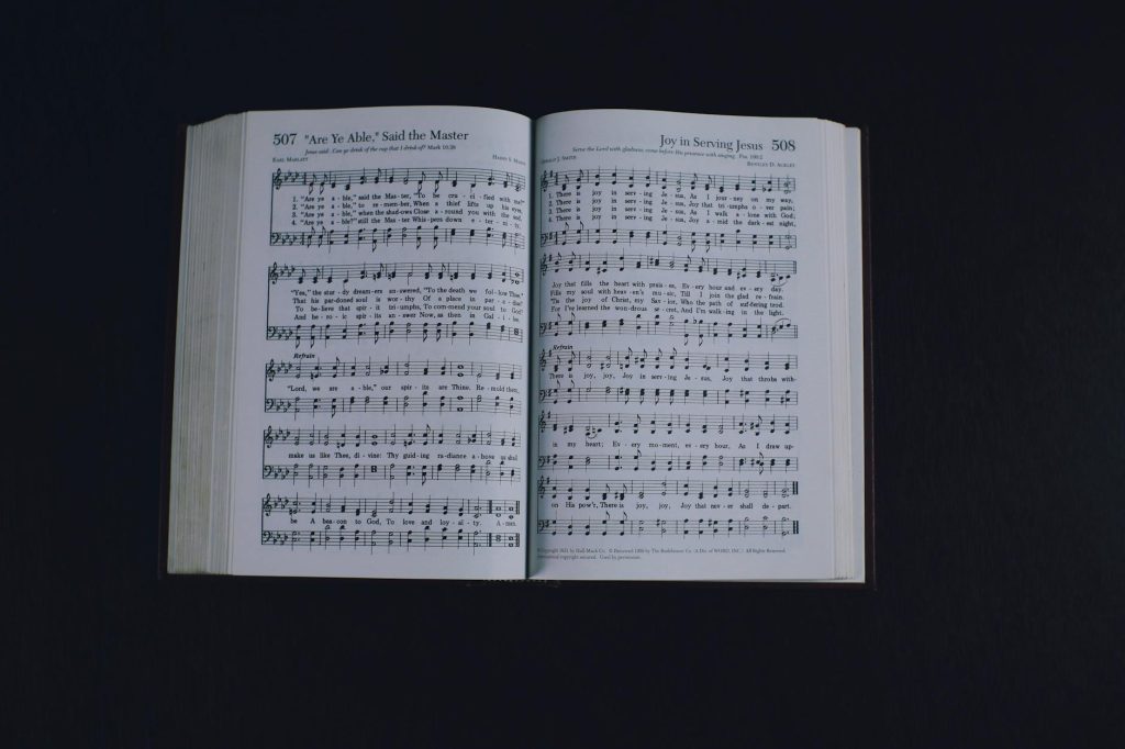 opened book with music notes against dark background